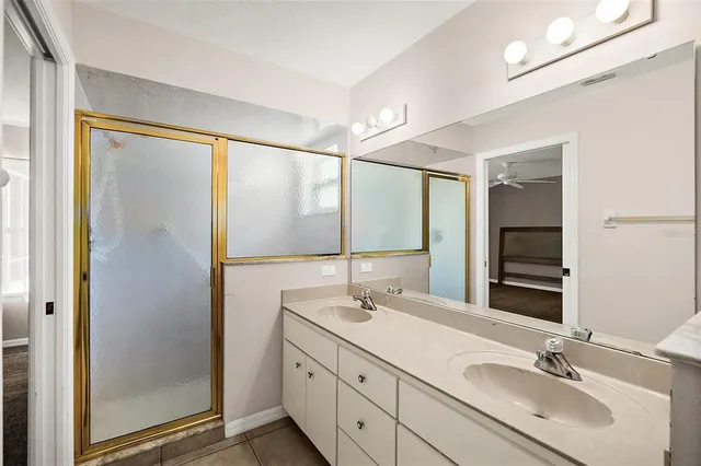 a bathroom with a double vanity sink and mirror