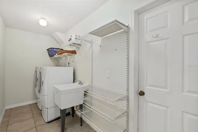 a hallway with a white cabinets and wooden floor