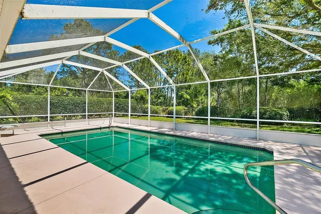 a view of a backyard with a swimming pool