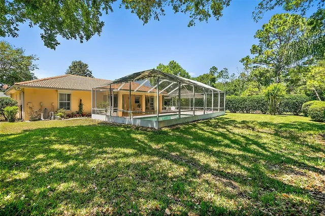 a front view of a house with swimming pool having outdoor seating