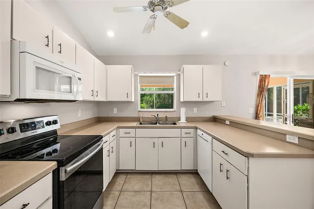 a kitchen with a sink stove and microwave