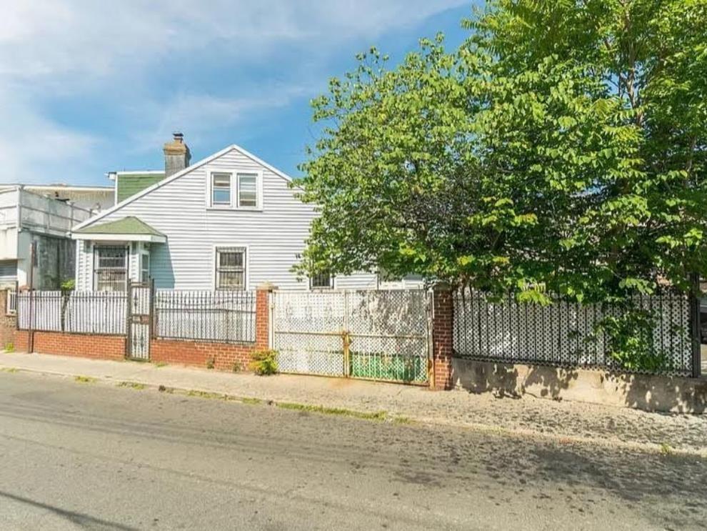 16 Brighton 10th Lane Brooklyn, NY 11235 - Photo 2 of 3 a view of a house with a backyard and a garage