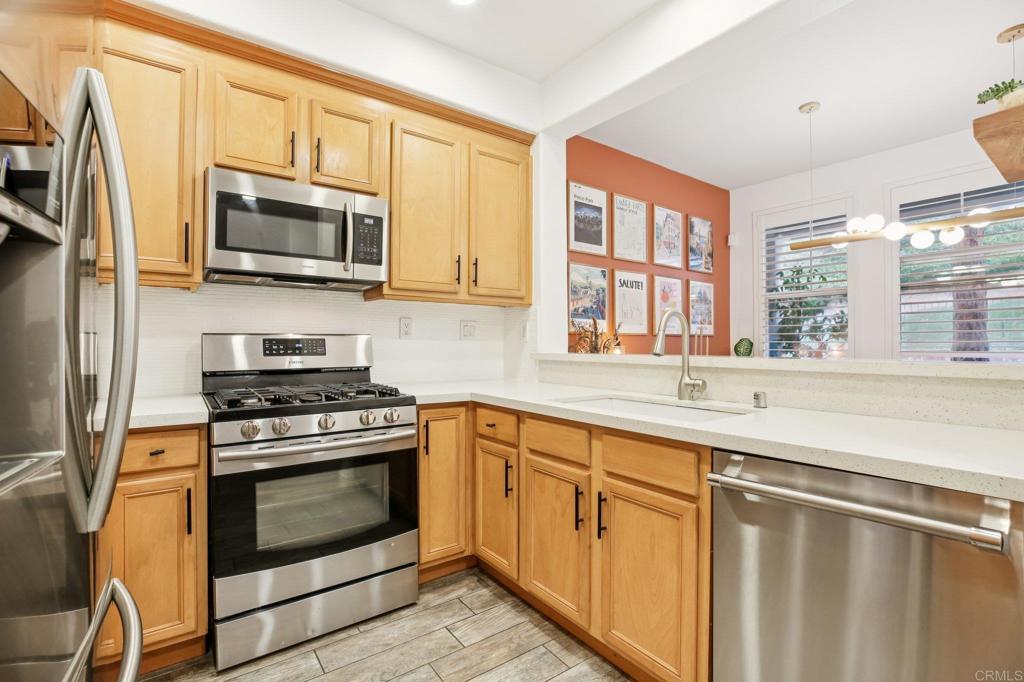 94 Hinterland Way Ladera Ranch, CA 92694 - Photo 11 of 52 a kitchen with stainless steel appliances granite countertop a stove microwave and sink
