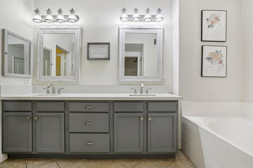 94 Hinterland Way Ladera Ranch, CA 92694 - Photo 20 of 52 a bathroom with a double vanity sink mirror and bathtub