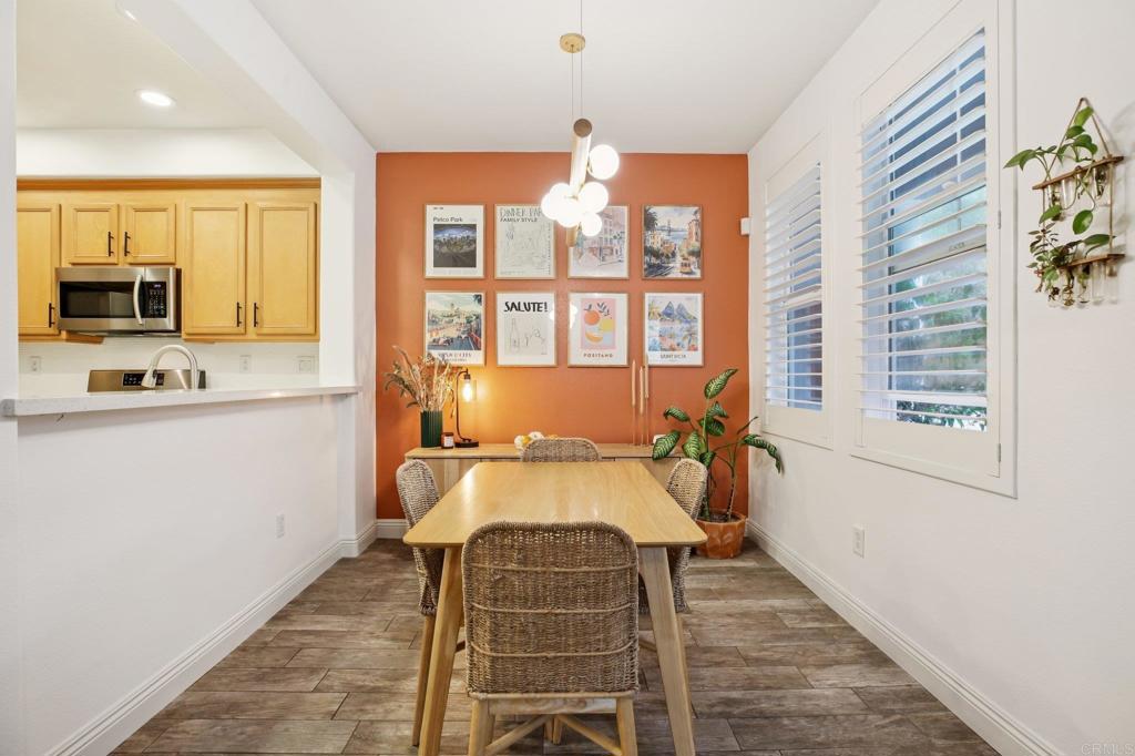 94 Hinterland Way Ladera Ranch, CA 92694 - Photo 8 of 52 a dining room with wooden floor and a window