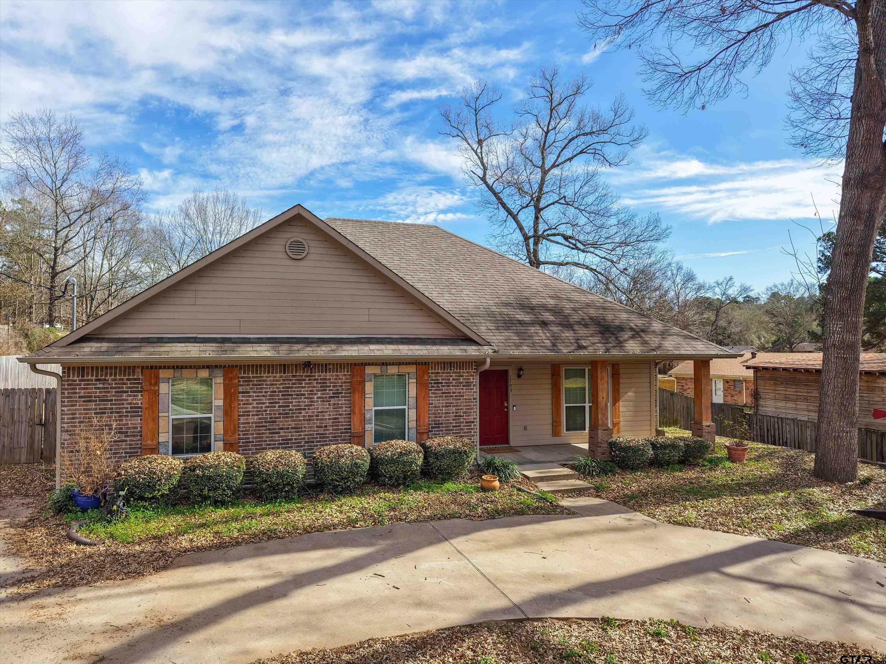 1703 Azalea Street Gilmer, TX 75644 - Photo 16 of 34 a front view of a house with a yard