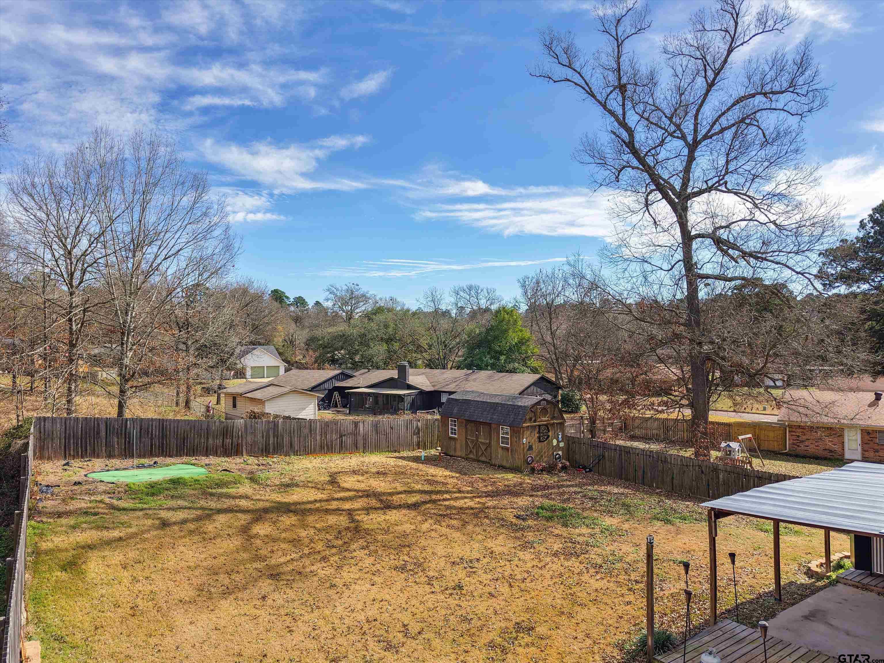 1703 Azalea Street Gilmer, TX 75644 - Photo 19 of 34 a view of a lake with a house in the background