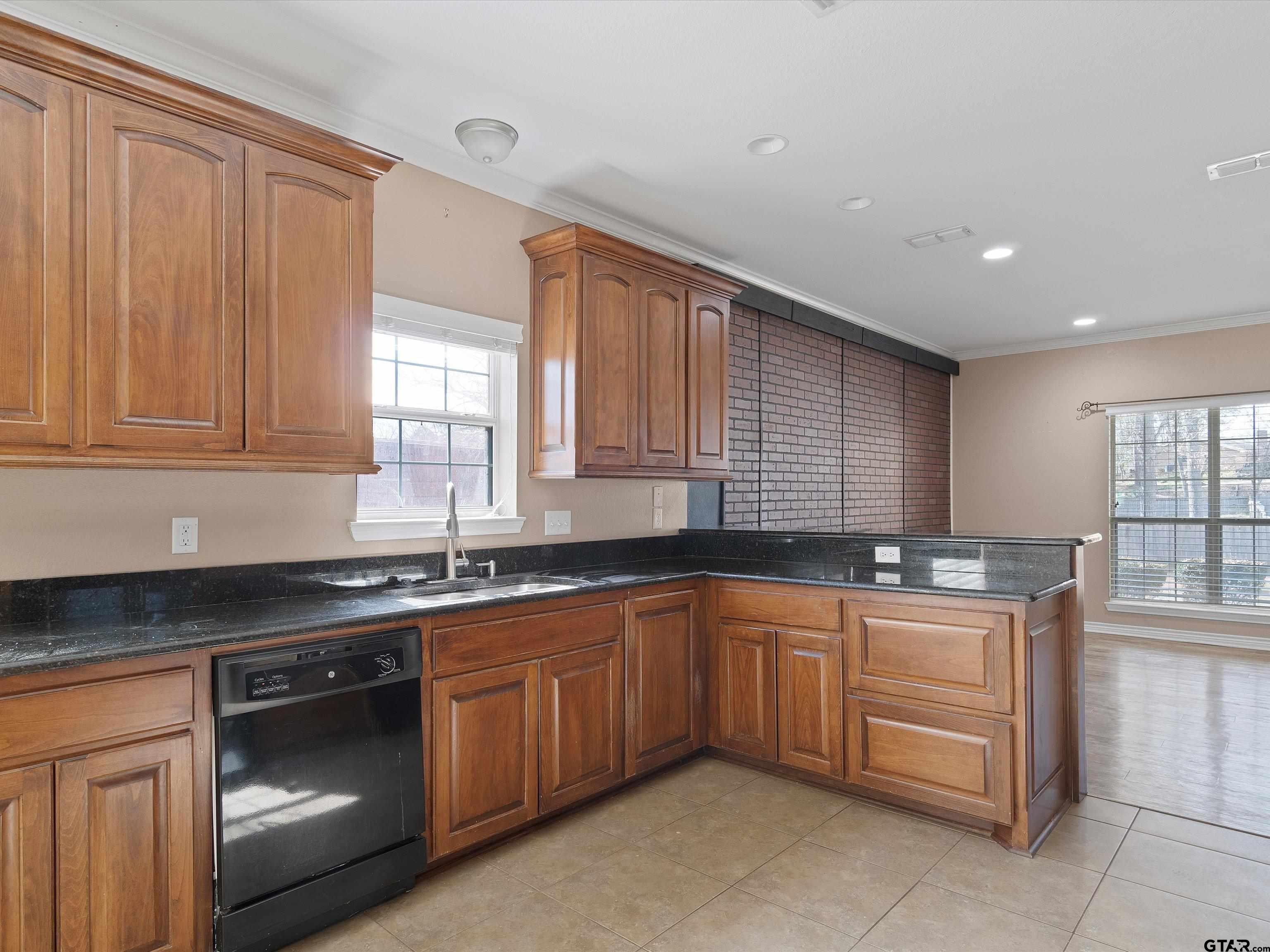 1703 Azalea Street Gilmer, TX 75644 - Photo 2 of 34 a kitchen with a sink and cabinets
