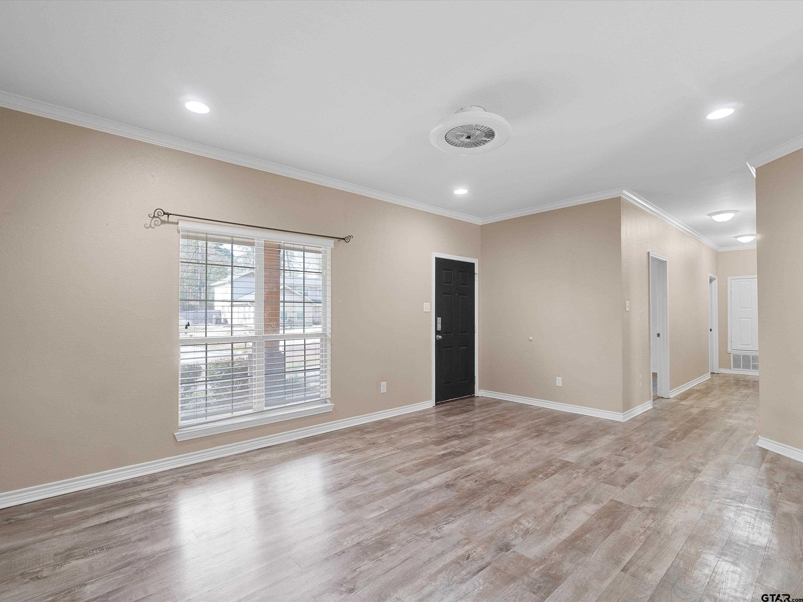 1703 Azalea Street Gilmer, TX 75644 - Photo 23 of 34 a view of an empty room with wooden floor and a window