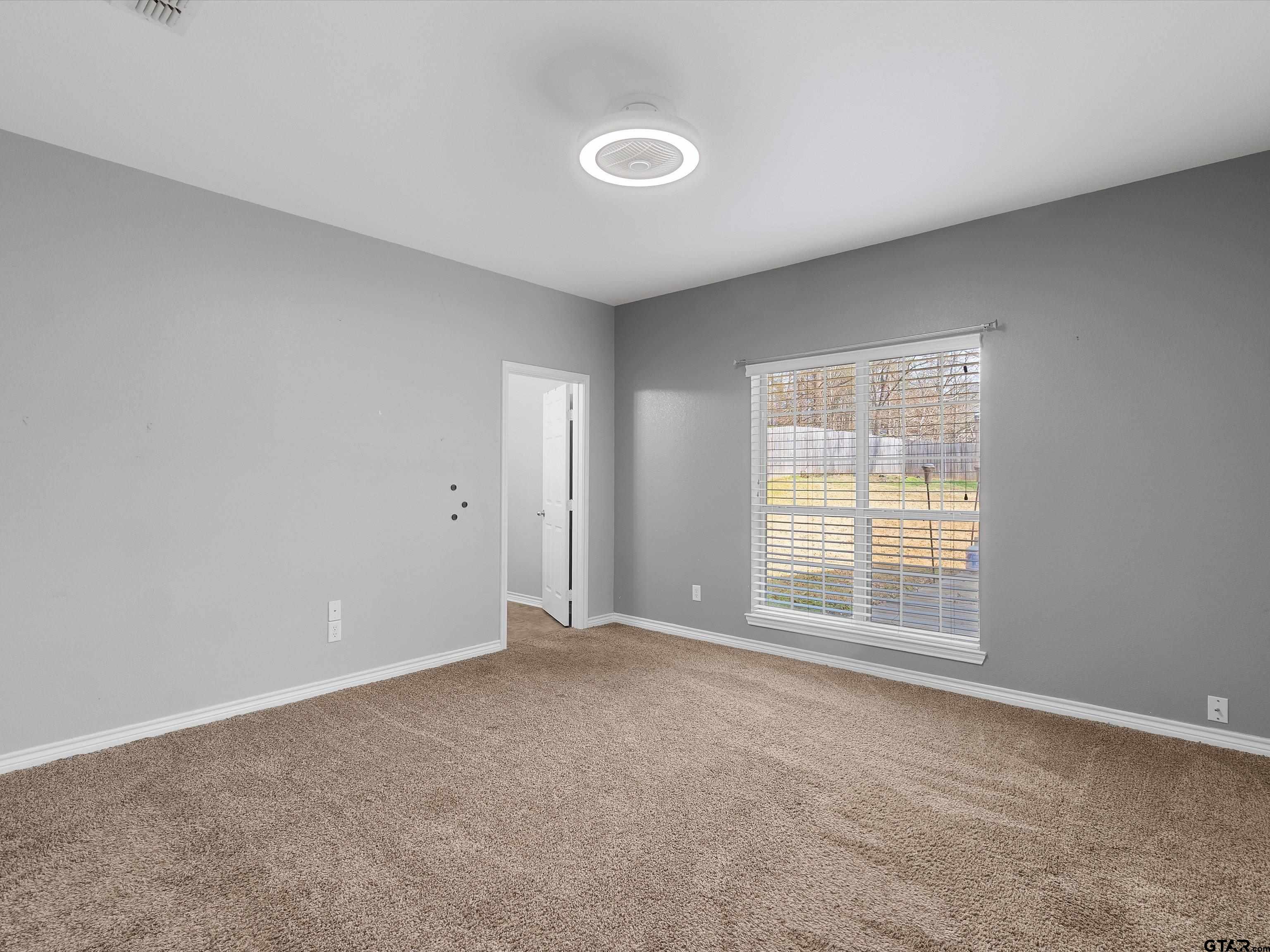 1703 Azalea Street Gilmer, TX 75644 - Photo 28 of 34 a view of an empty room with a window