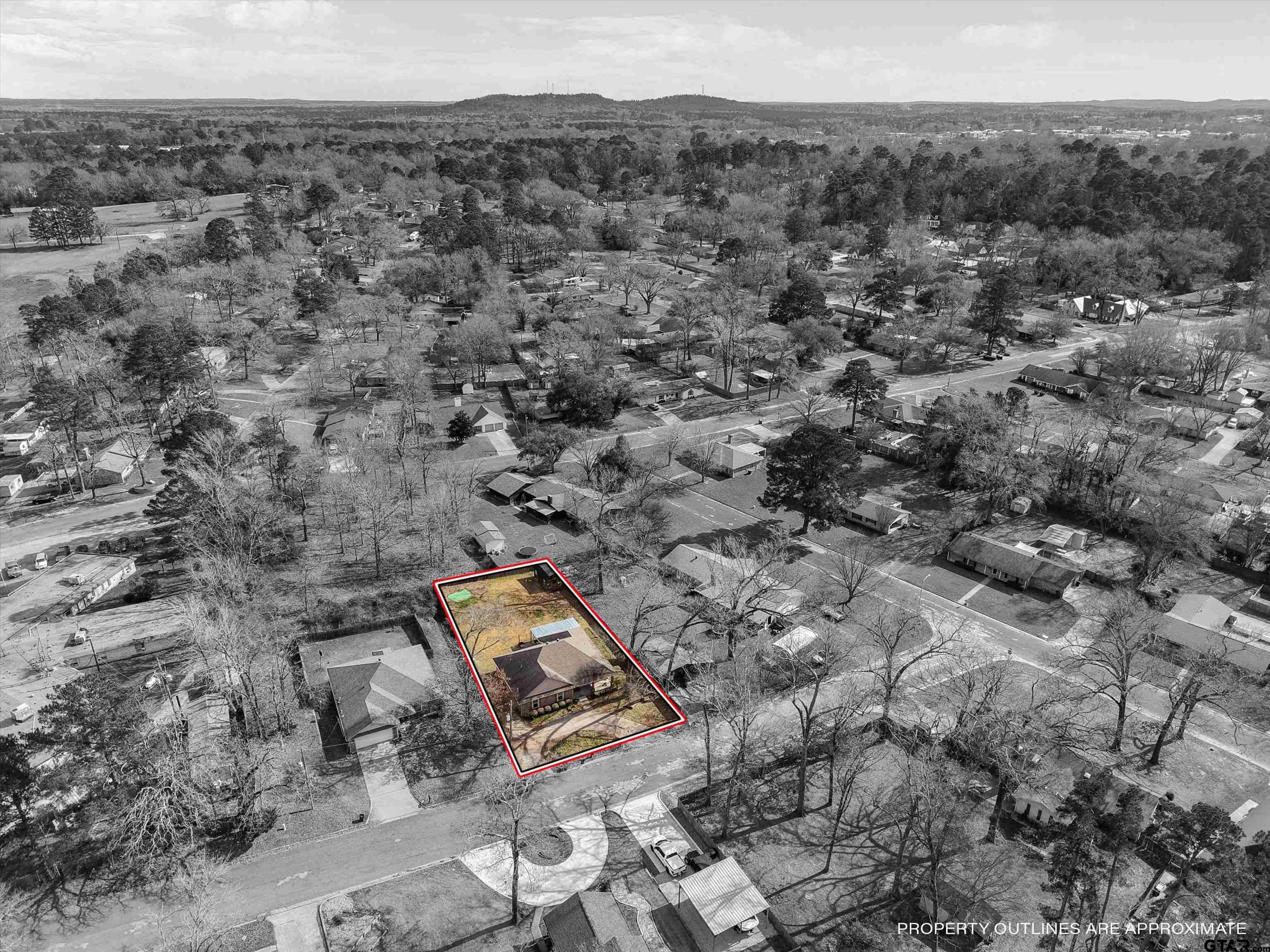 1703 Azalea Street Gilmer, TX 75644 - Photo 33 of 34 an aerial view of a house with a yard