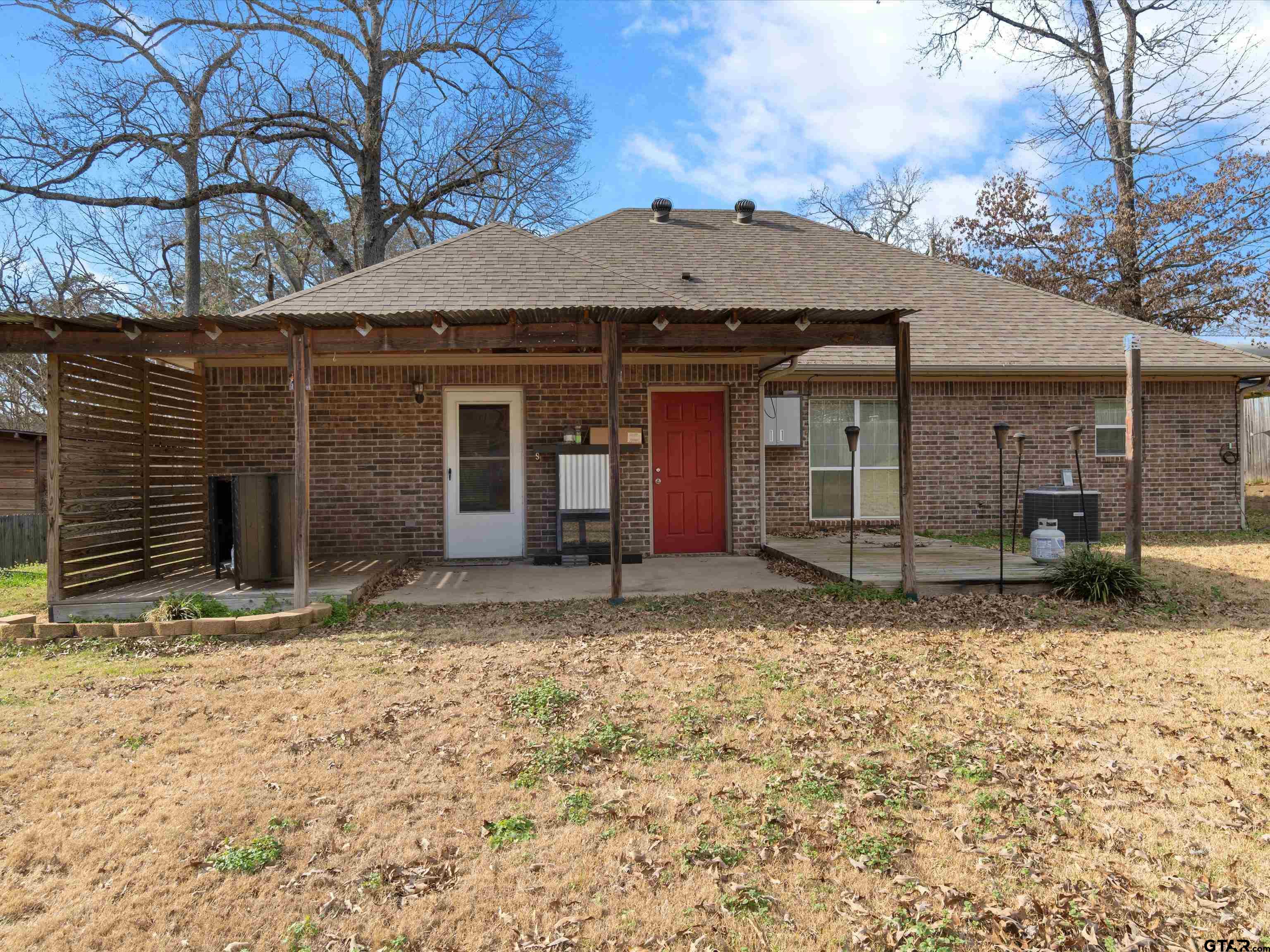 1703 Azalea Street Gilmer, TX 75644 - Photo 9 of 34 a view of a house with a yard