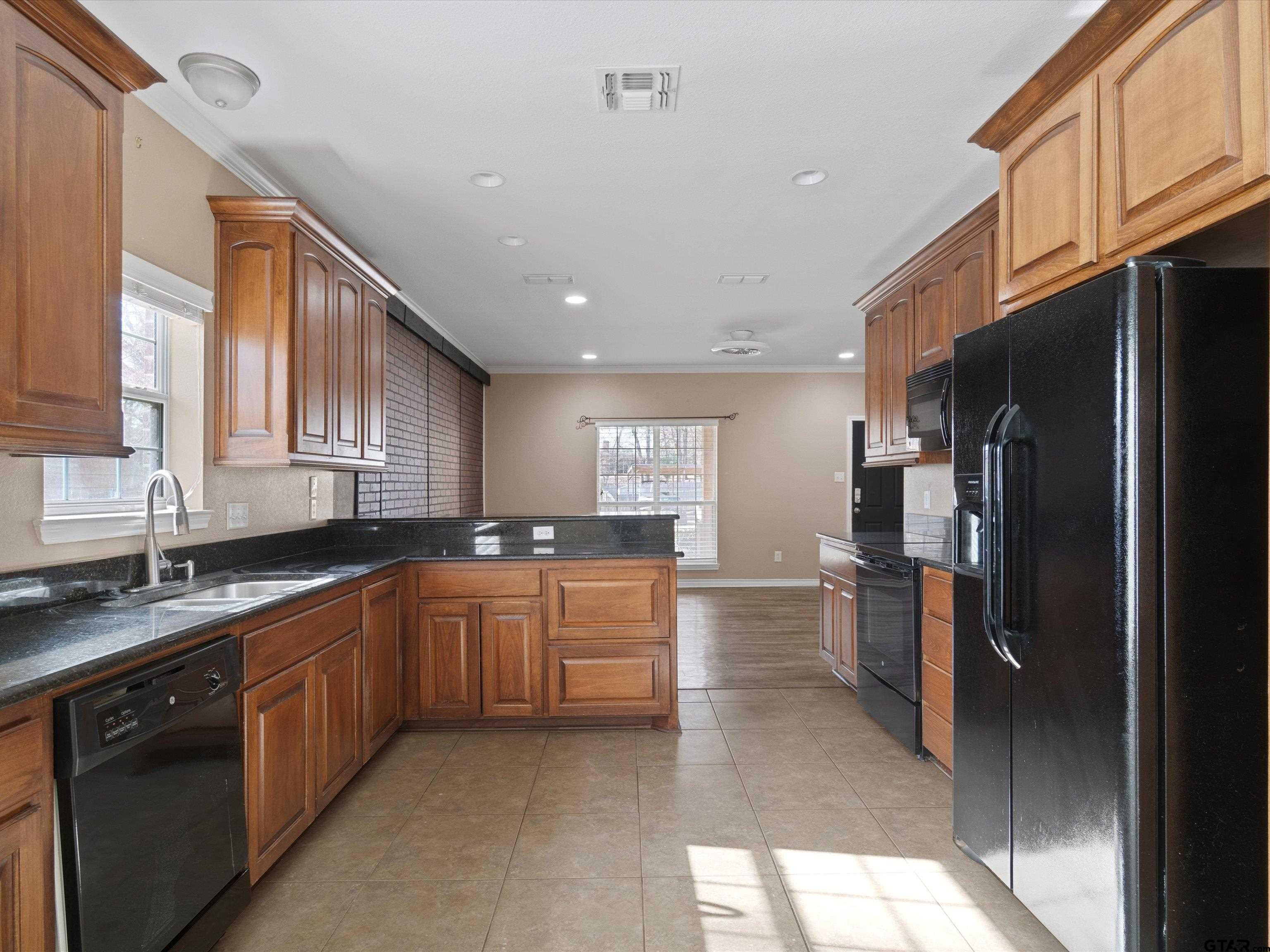 1703 Azalea Street Gilmer, TX 75644 - Photo 10 of 34 a large kitchen with stainless steel appliances lots of counter top space