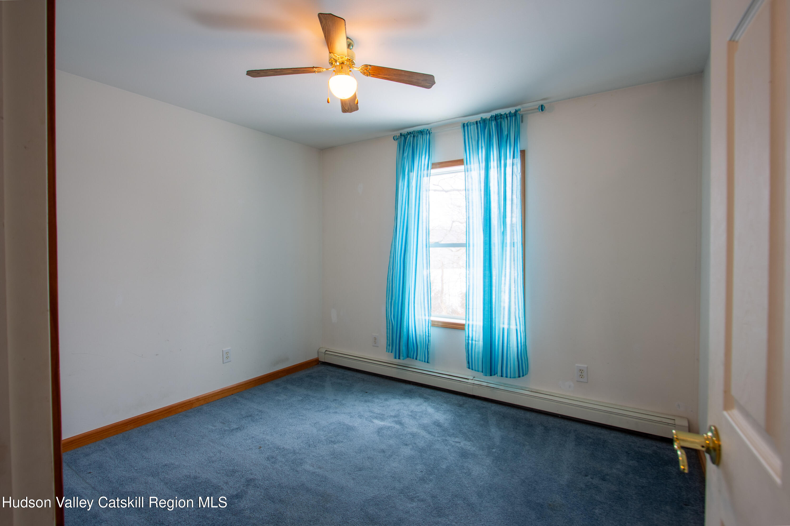 521 White Mills Road Valatie, NY 12184 - Photo 13 of 17 an empty room with windows and chandelier fan