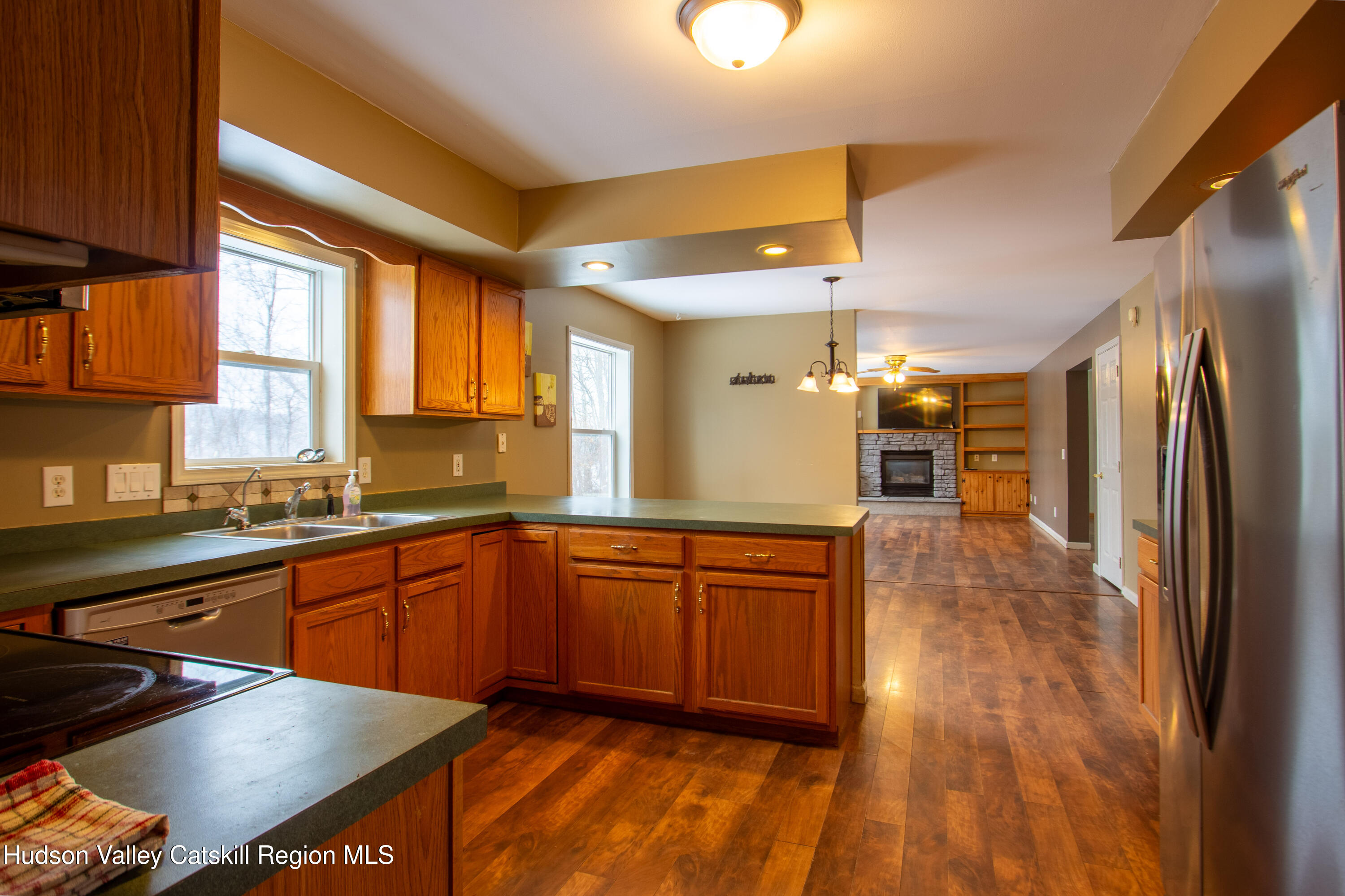 521 White Mills Road Valatie, NY 12184 - Photo 3 of 17 a kitchen with stainless steel appliances granite countertop a sink and wooden cabinets