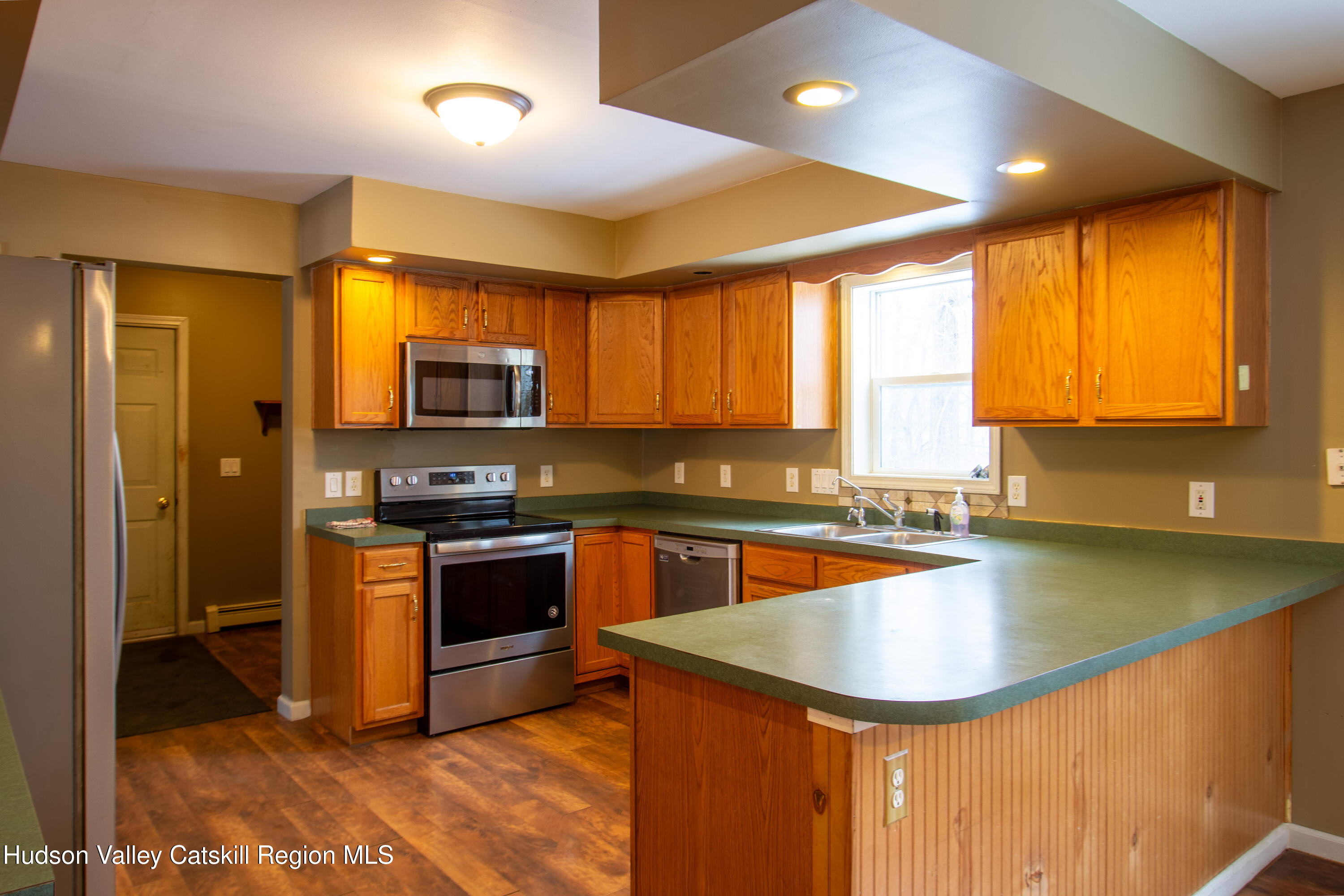 521 White Mills Road Valatie, NY 12184 - Photo 4 of 17 a kitchen with stainless steel appliances granite countertop a sink a stove and a refrigerator