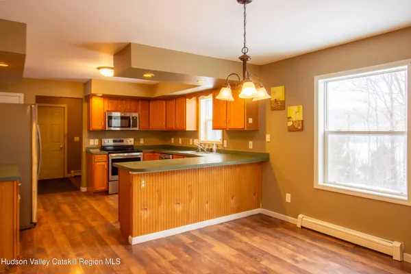 a kitchen with stainless steel appliances granite countertop a sink a stove and a refrigerator