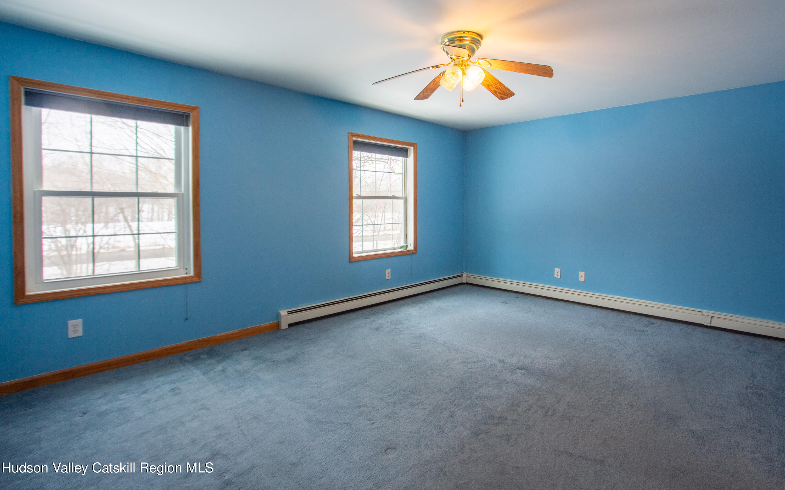 521 White Mills Road Valatie, NY 12184 - Photo 9 of 17 an empty room with windows and chandelier fan