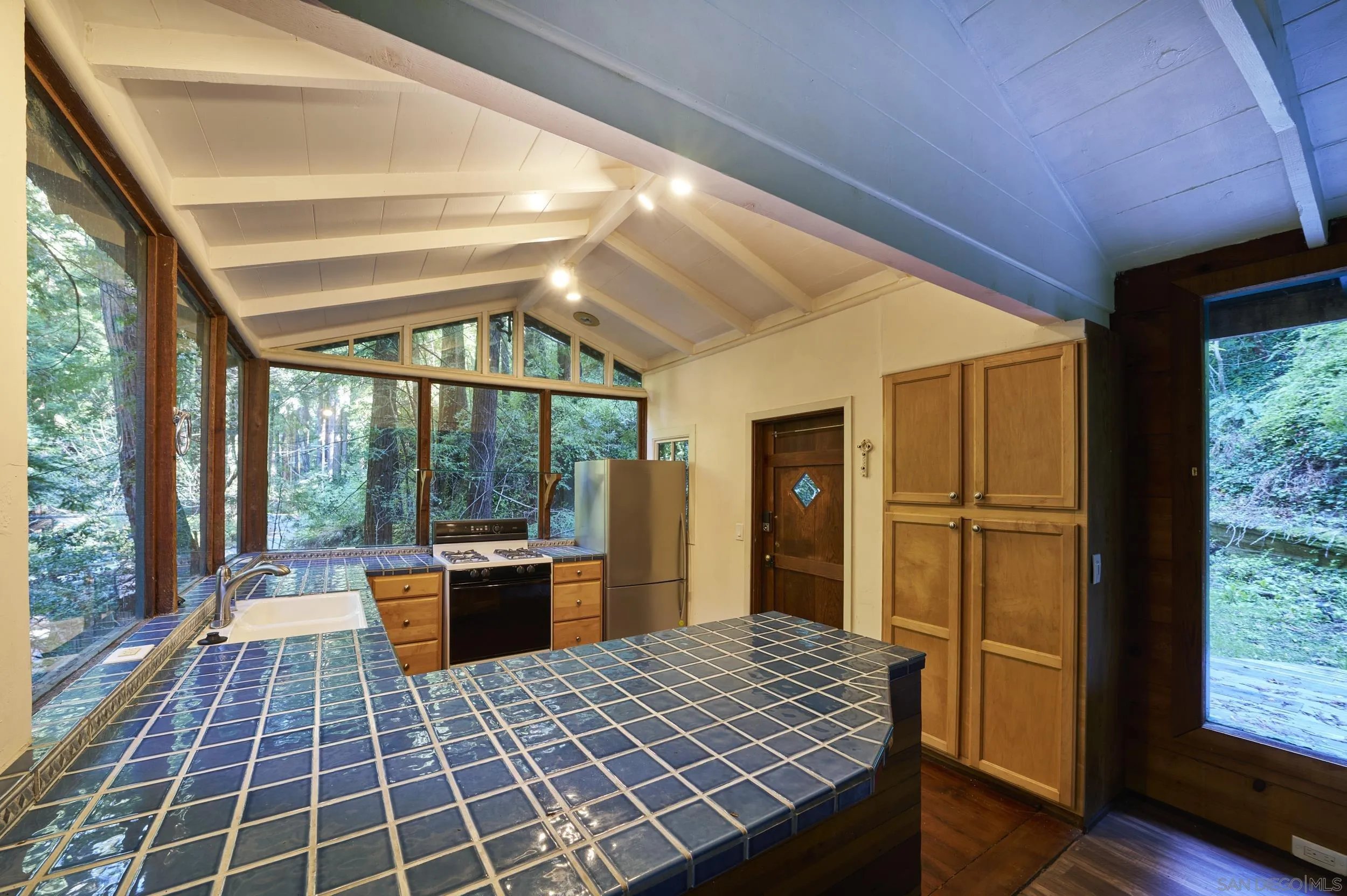 37016 Palo Colorado Road Carmel, CA 93923 - Photo 10 of 26 a room with wooden floor and large windows