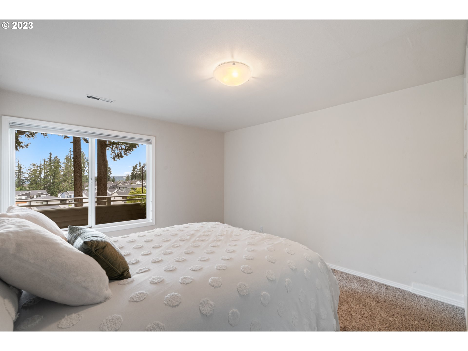 3490 Chaparrel Loop West Linn, OR 97068 - Photo 20 of 35 a bedroom with a large bed and a large window