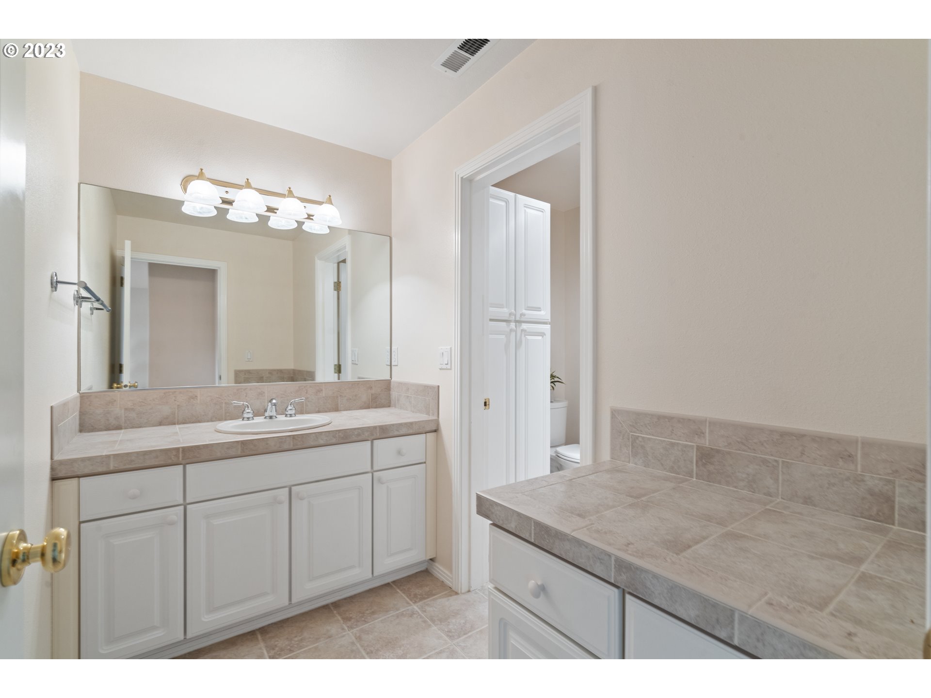 3490 Chaparrel Loop West Linn, OR 97068 - Photo 21 of 35 a bathroom with a granite countertop sink a large mirror and a