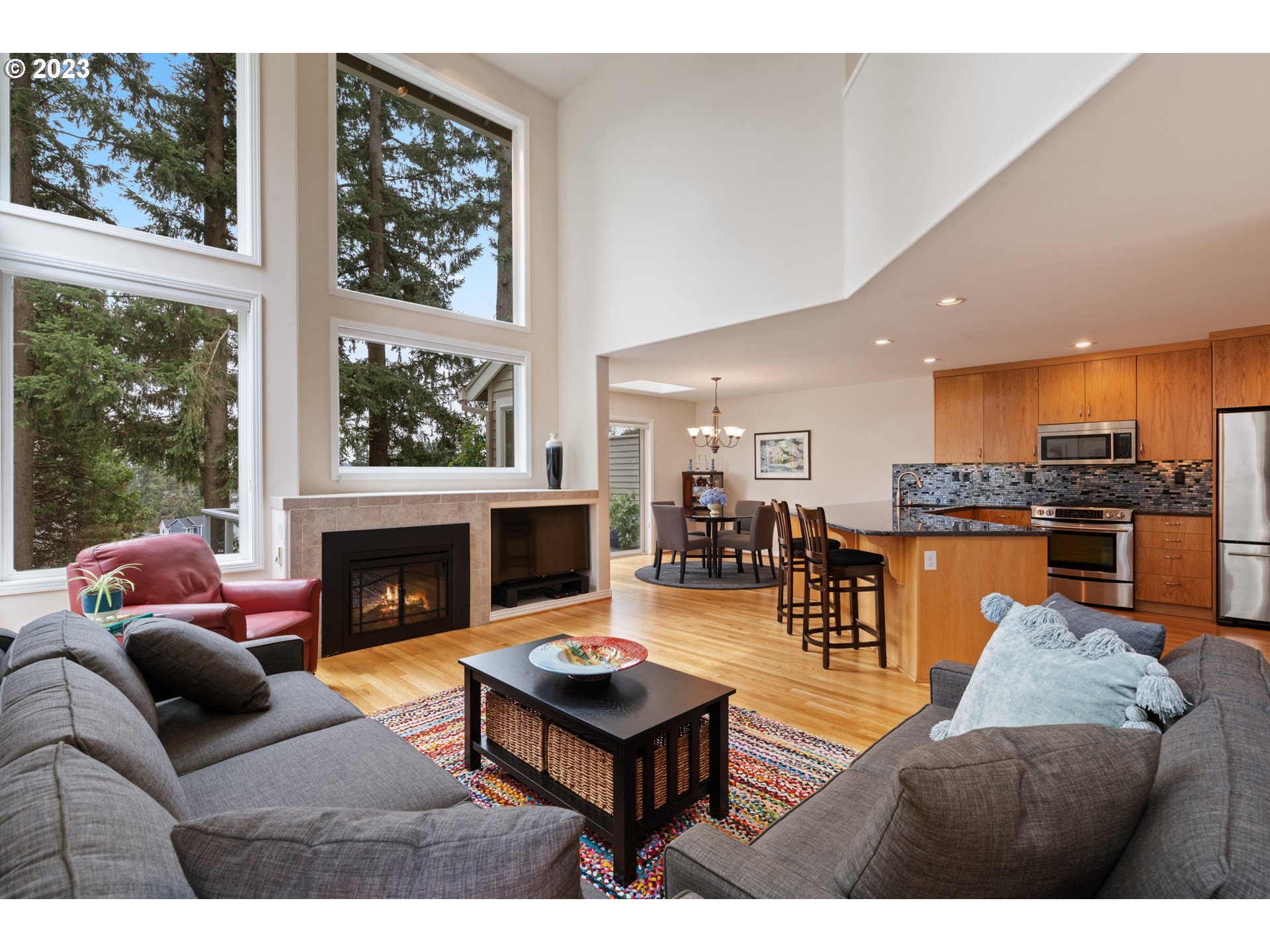 3490 Chaparrel Loop West Linn, OR 97068 - Photo 6 of 35 a living room with furniture a table and a fireplace