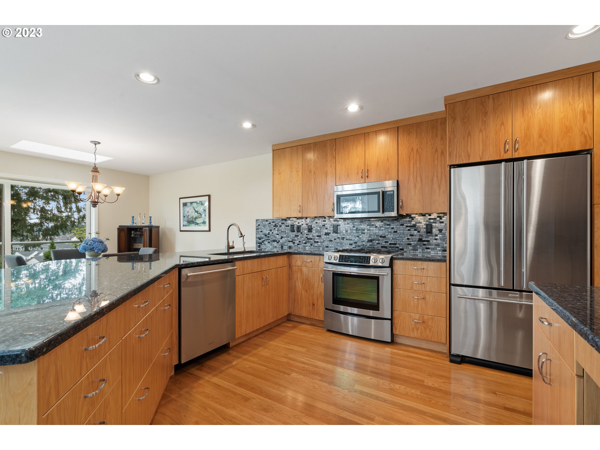 3490 Chaparrel Loop West Linn, OR 97068 - Photo 9 of 35 a kitchen with granite countertop a refrigerator and a sink
