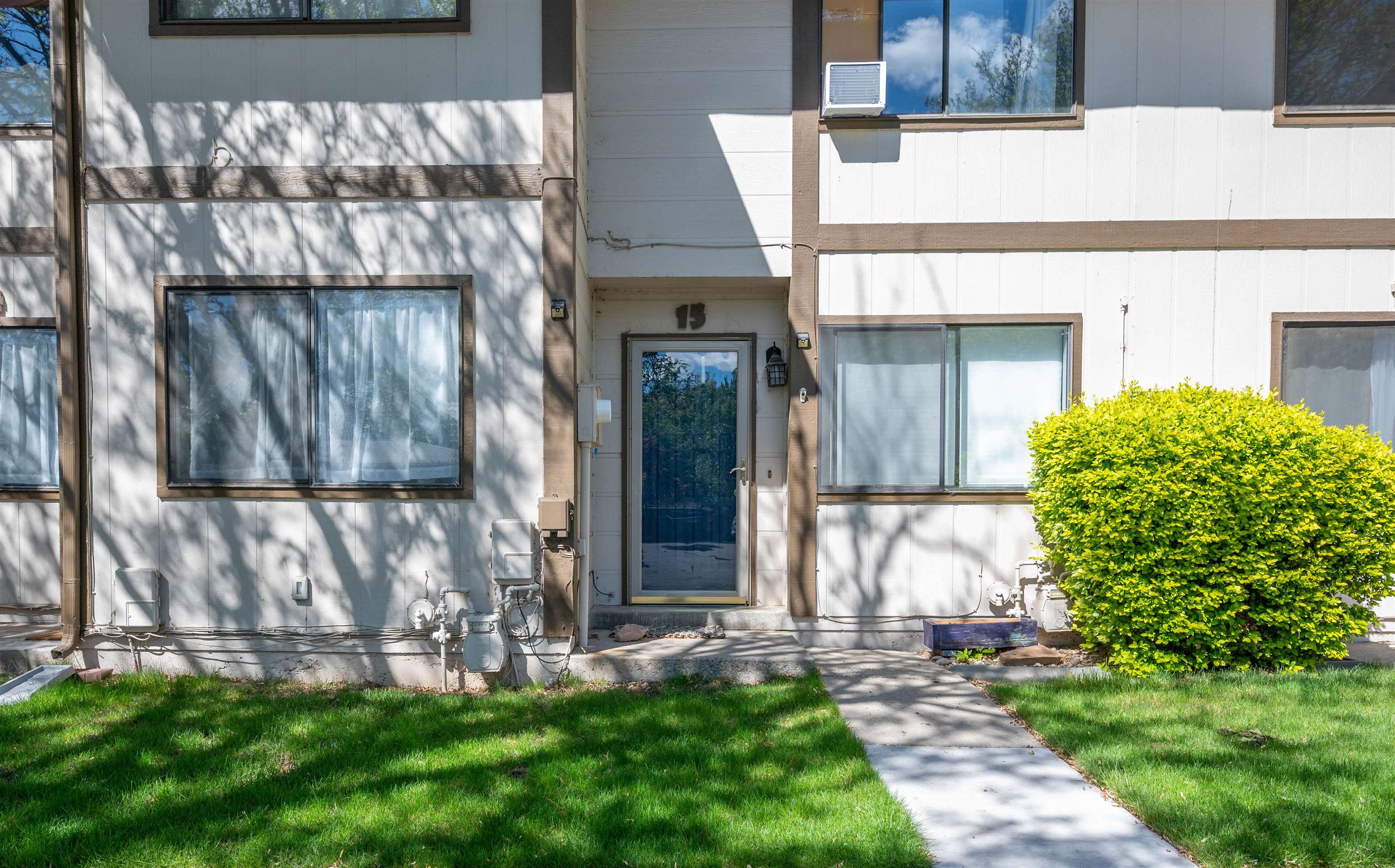 555-28 28 1/2 Road, Unit 15 Grand Junction, CO 81501 - Photo 1 of 26 a view of a house with a small yard and wooden fence