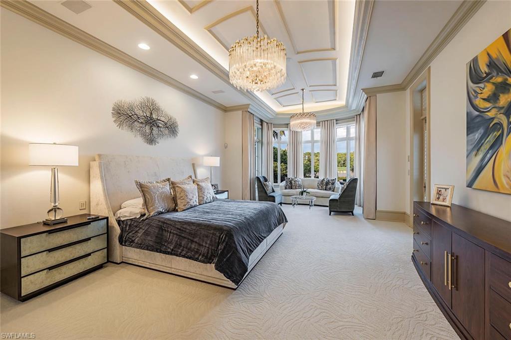 1420 Nighthawk Pointe Naples, FL 34105 - Photo 11 of 14 a spacious bedroom with a bed couch and a chandelier