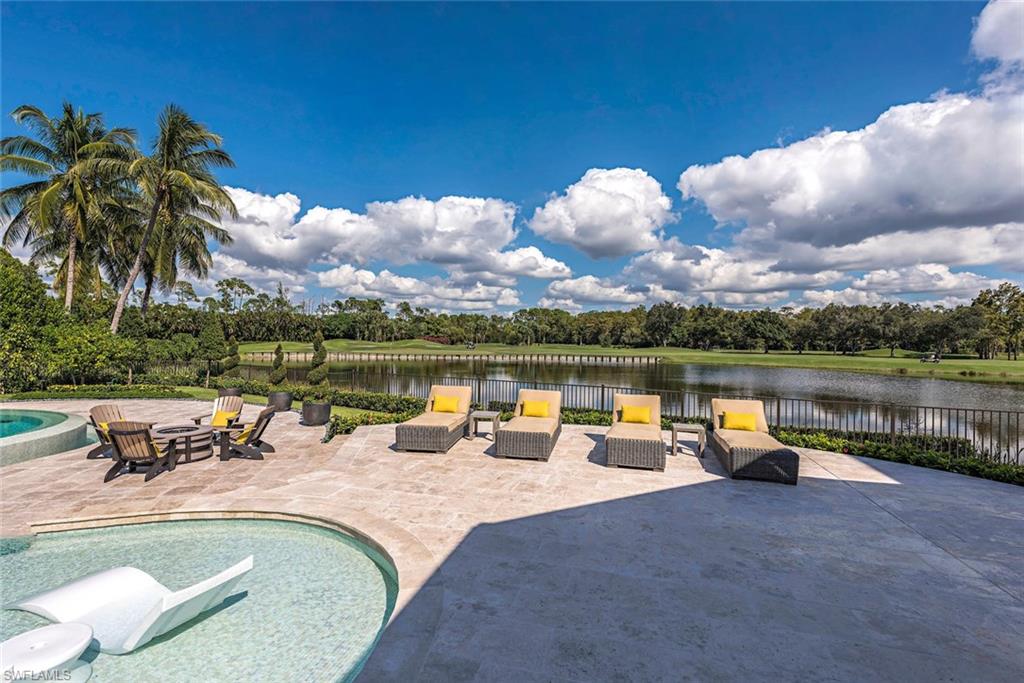 1420 Nighthawk Pointe Naples, FL 34105 - Photo 2 of 14 a view of swimming pool with a table and chairs