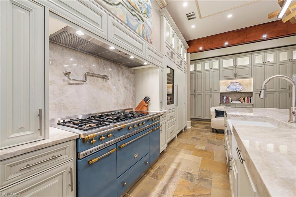 1420 Nighthawk Pointe Naples, FL 34105 - Photo 7 of 14 a kitchen with stainless steel appliances granite countertop a stove and a refrigerator