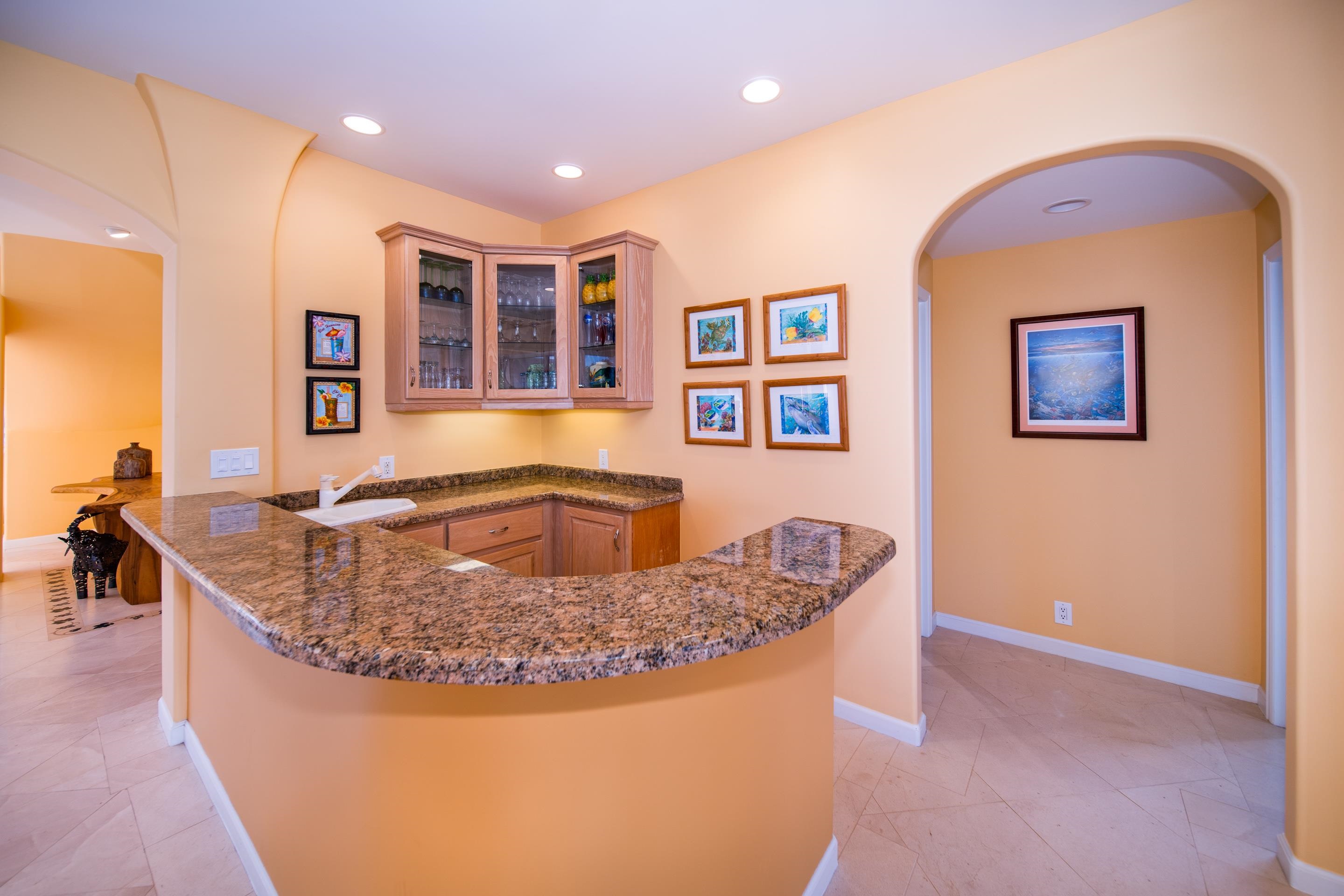 135 Kaimanu Place Kihei, HI 96753 - Photo 11 of 29 a kitchen with stainless steel appliances granite countertop a sink a stove and a wooden floors