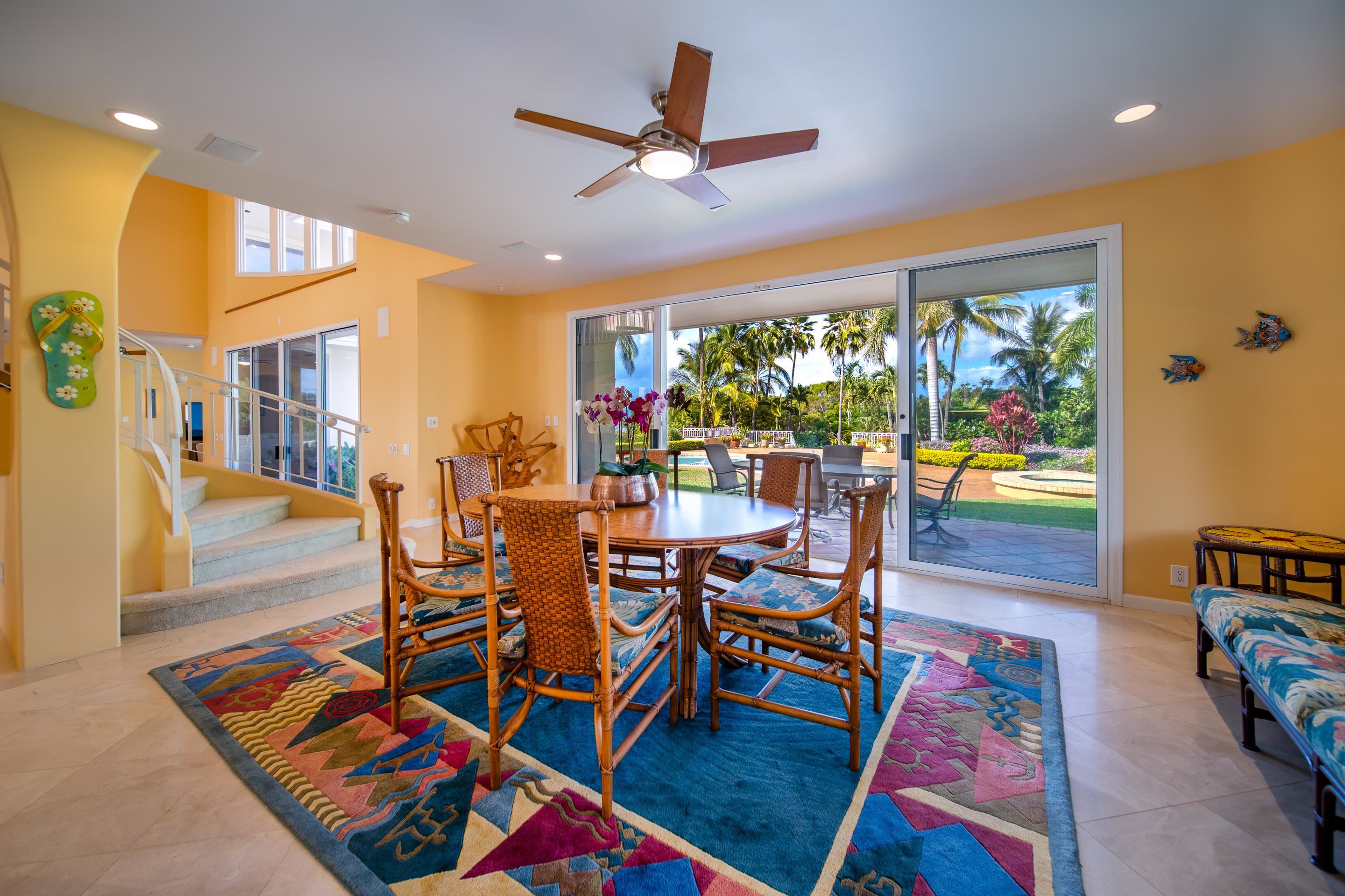 135 Kaimanu Place Kihei, HI 96753 - Photo 12 of 29 a living room with furniture a rug and a floor to ceiling window