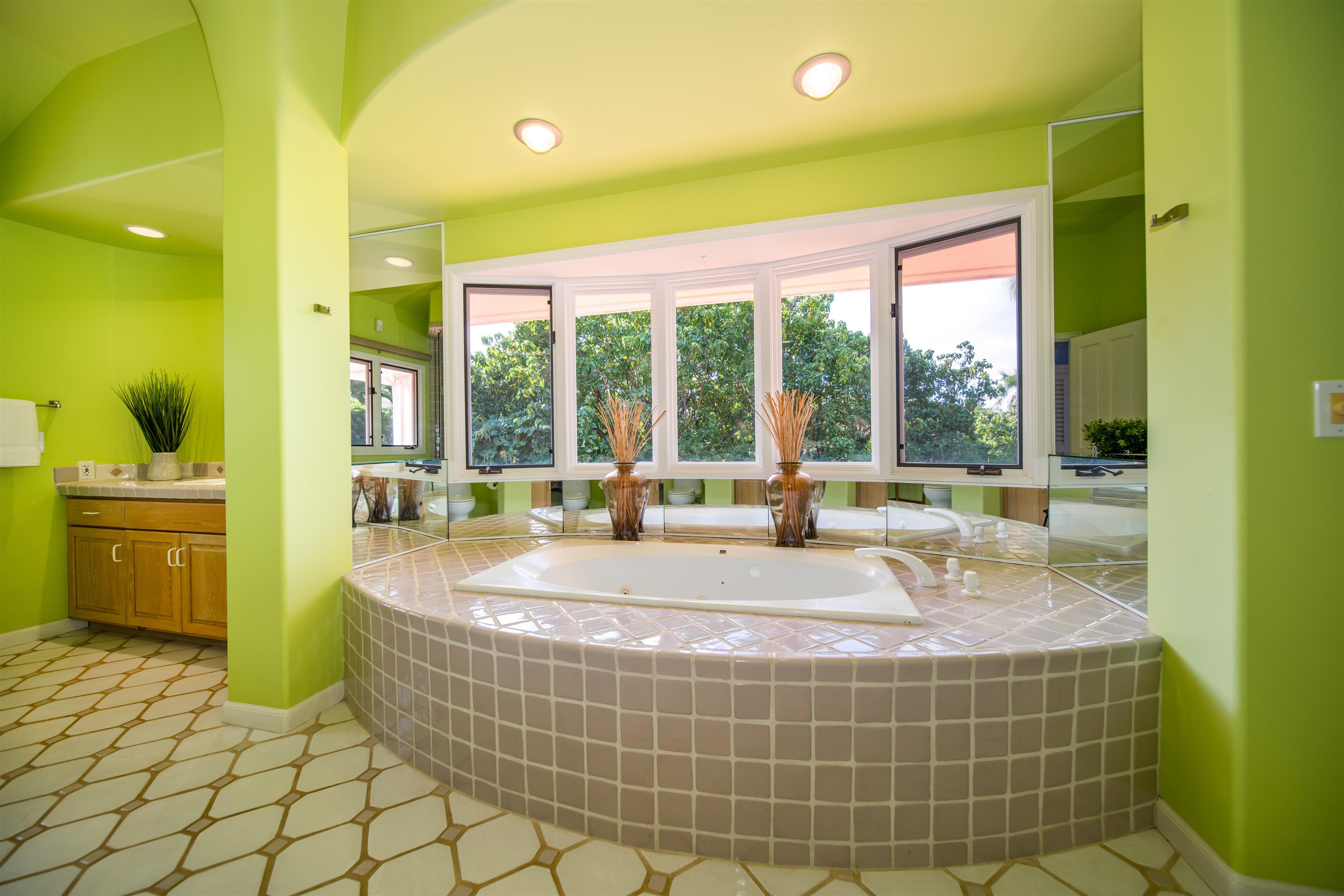135 Kaimanu Place Kihei, HI 96753 - Photo 18 of 29 a living room with a large window and dinning table and chairs