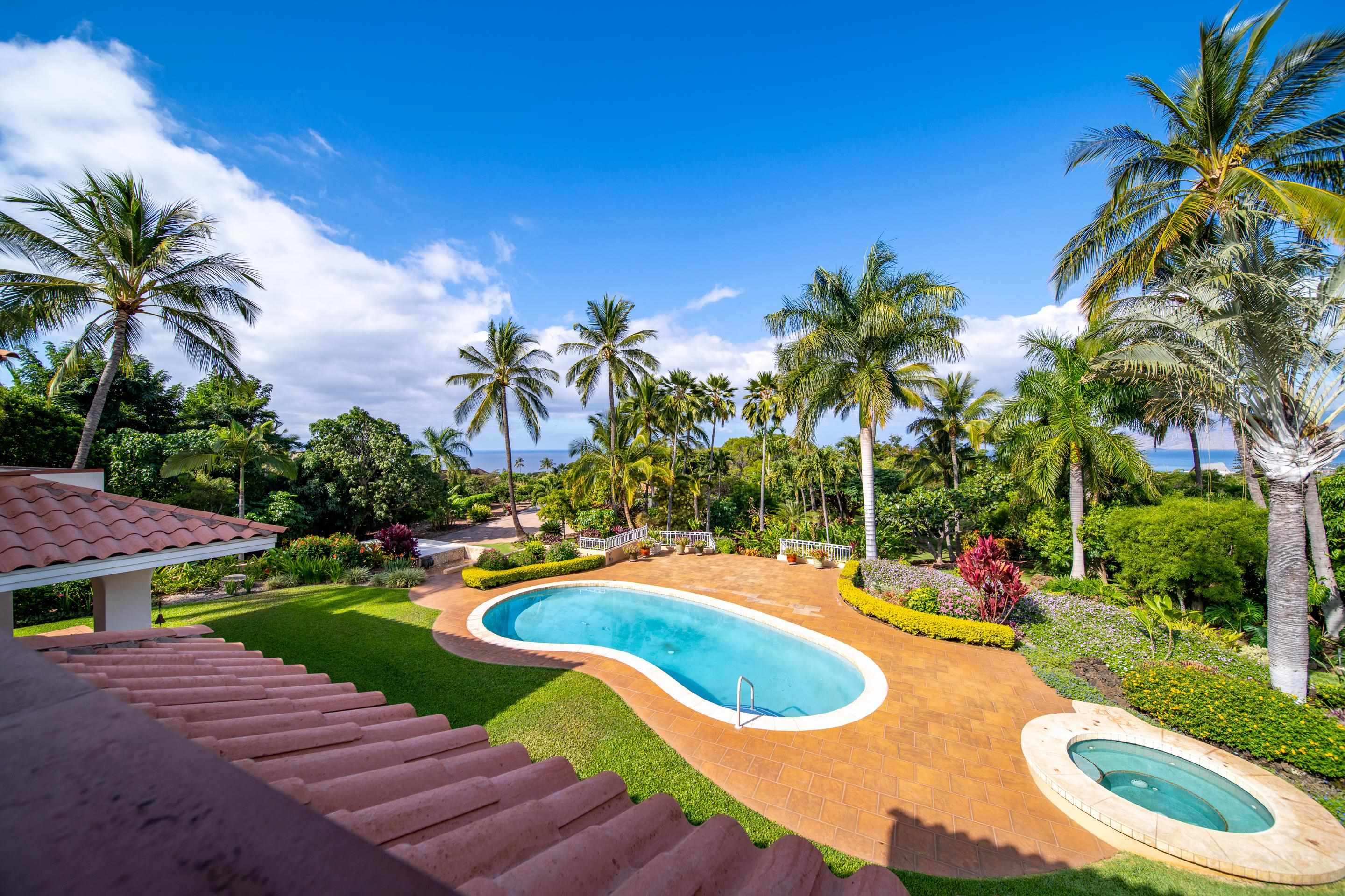 135 Kaimanu Place Kihei, HI 96753 - Photo 21 of 29 a view of a swimming pool with a yard and plants