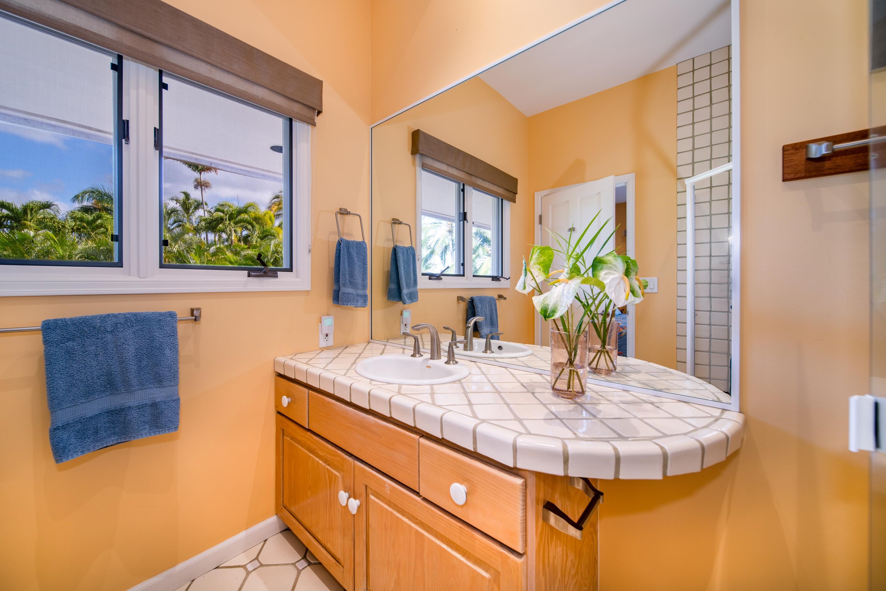 135 Kaimanu Place Kihei, HI 96753 - Photo 24 of 29 a bathroom with a granite countertop sink and a mirror
