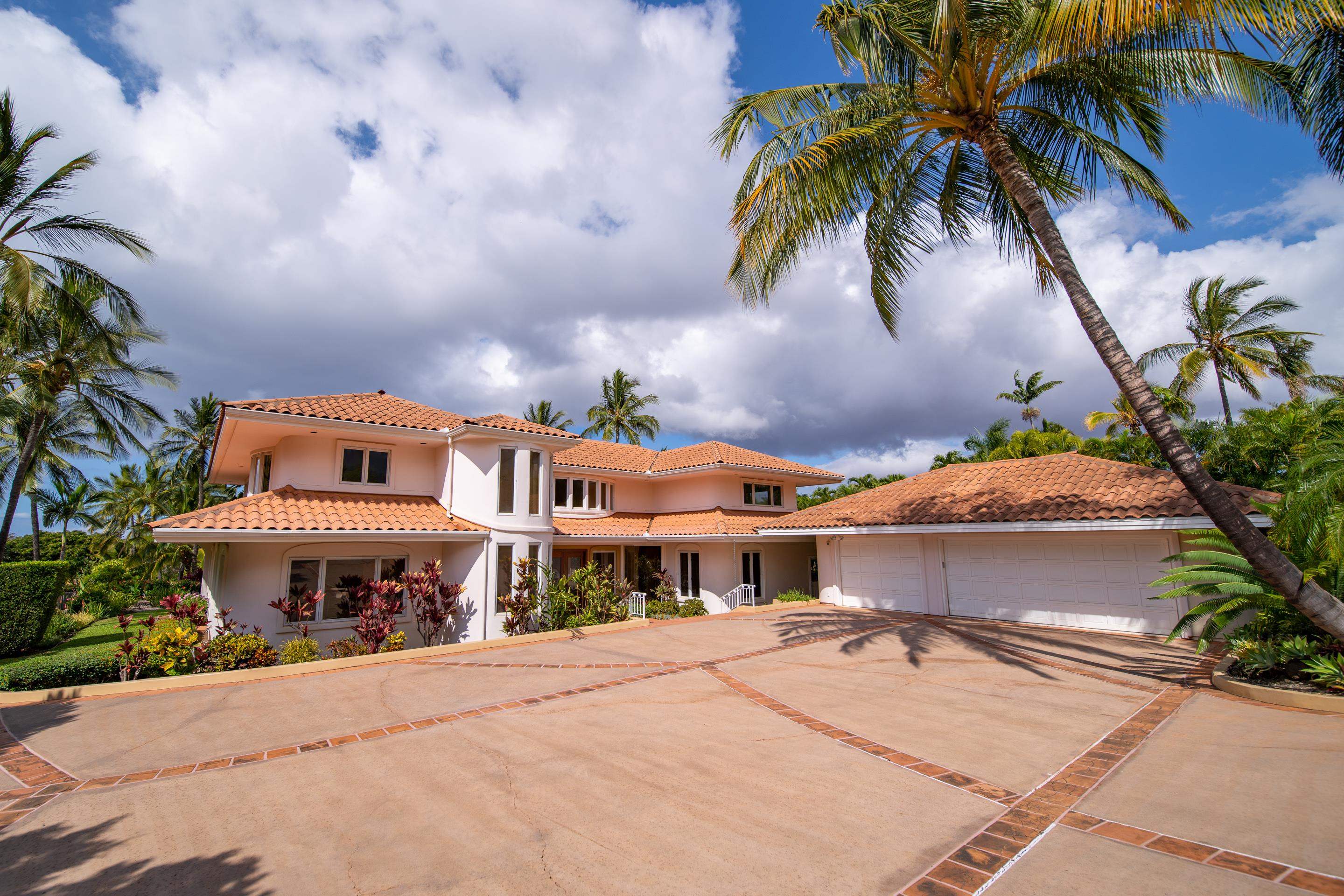 135 Kaimanu Place Kihei, HI 96753 - Photo 28 of 29 a front view of a house with a yard and palm trees