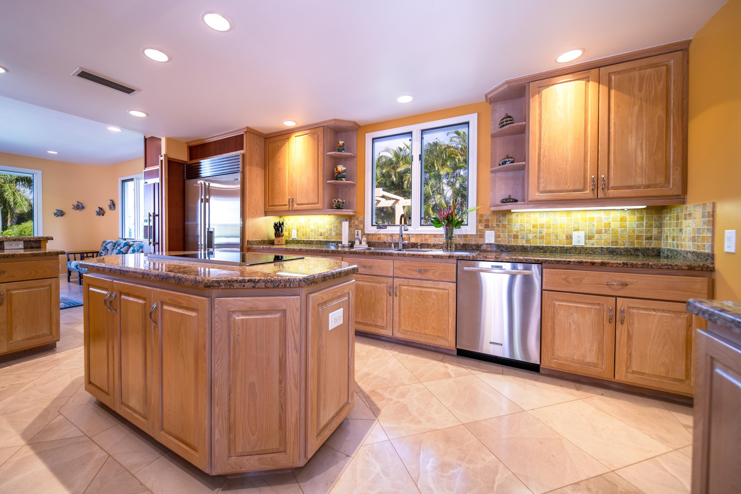 135 Kaimanu Place Kihei, HI 96753 - Photo 10 of 29 a kitchen with stainless steel appliances granite countertop a stove a sink dishwasher and a microwave