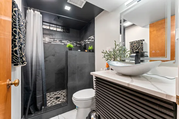 a bathroom with a sink toilet and shower