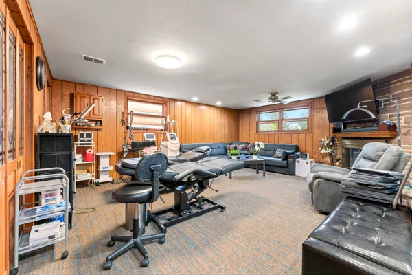 a view of a livingroom with workspace and a window