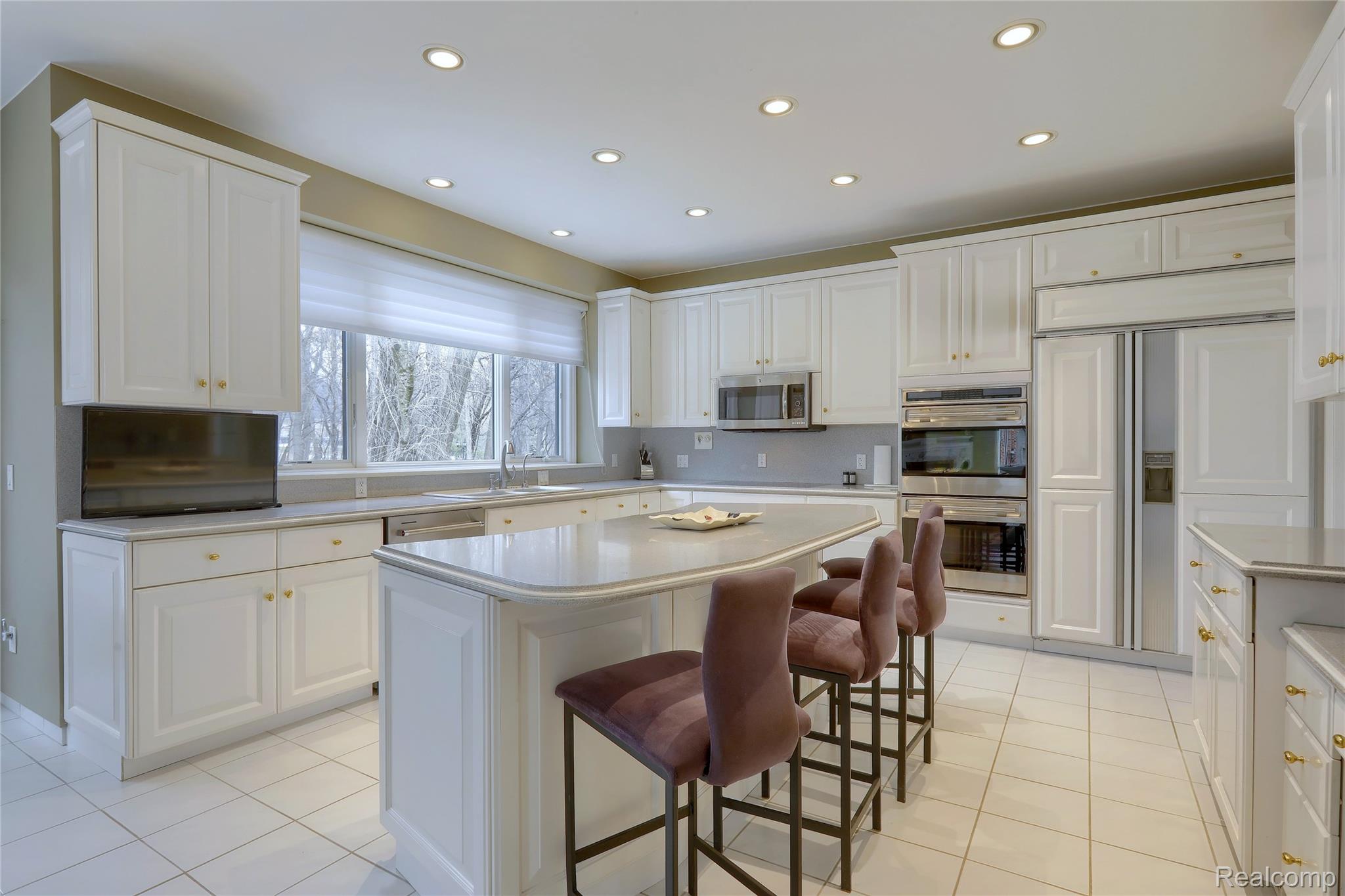 1721 Archers Pointe Rochester, MI 48306 - Photo 19 of 58 Kitchen with a breakfast bar area, recessed lighting, a kitchen island, and light tile patterned floors
