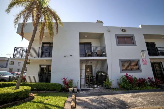 a front view of a house with yard and green space