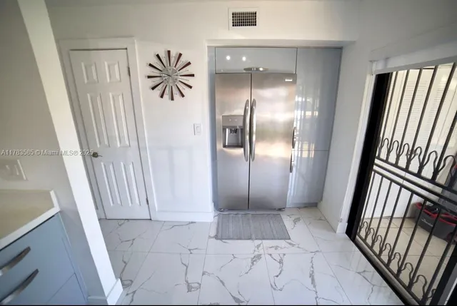 a view of entryway with stairs and door