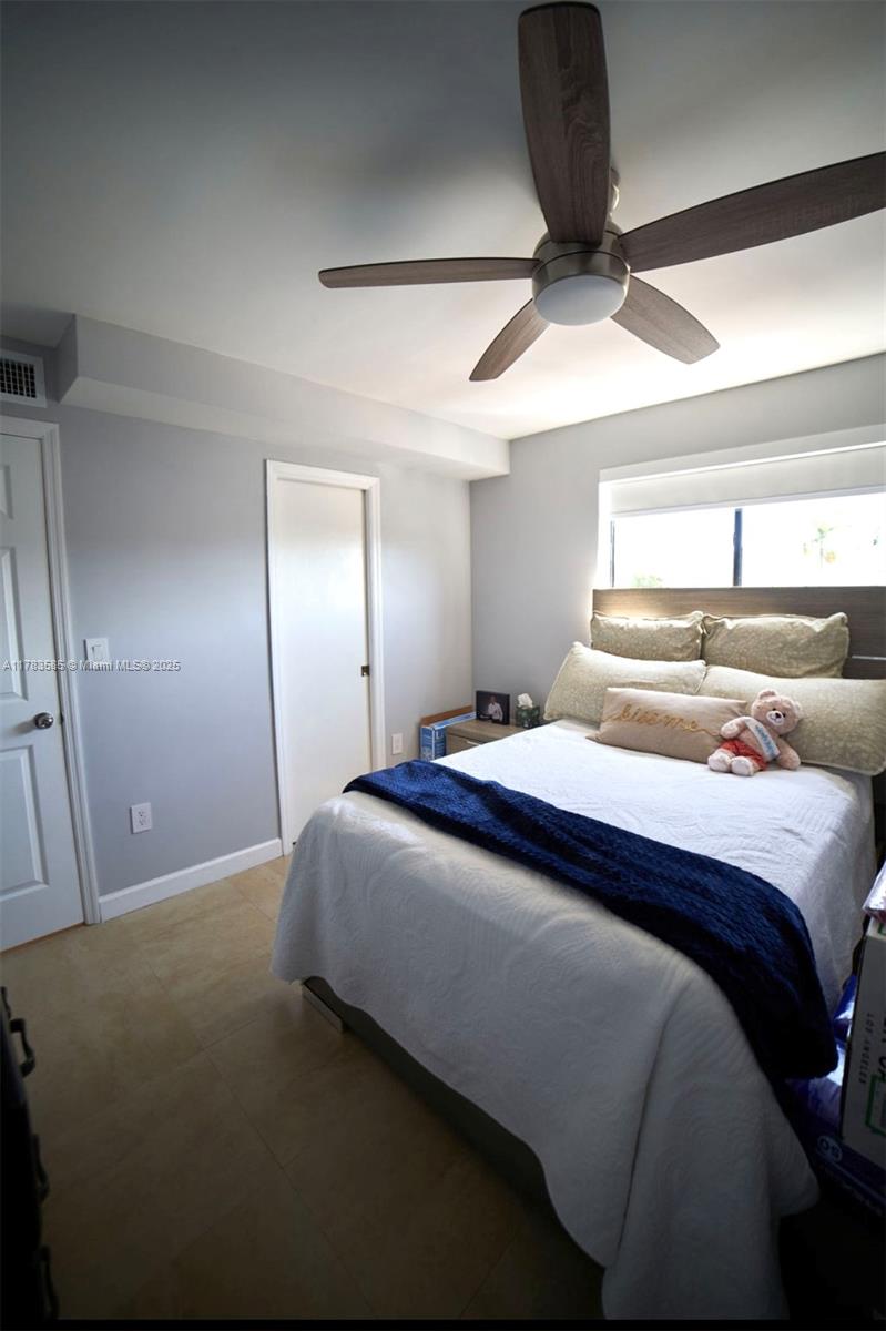1380 West 41st Street, Unit 101 Hialeah, FL 33012 - Photo 20 of 23 a bedroom with a bed and a chandelier