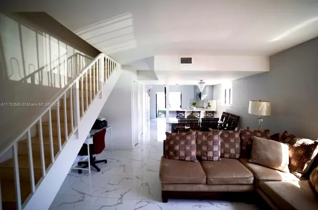 a living room with furniture or stairs and a view of living room