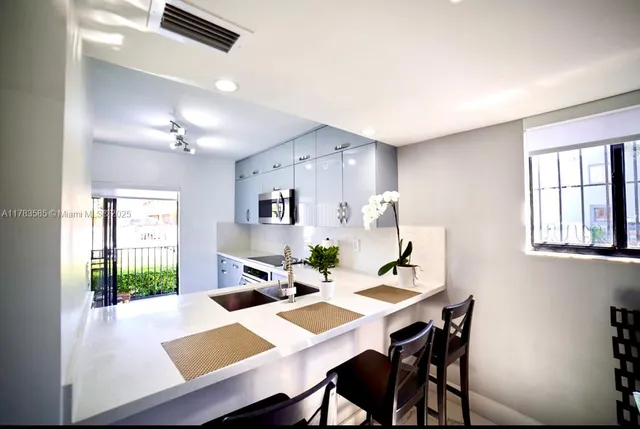 a view of a dining room with a table and chairs
