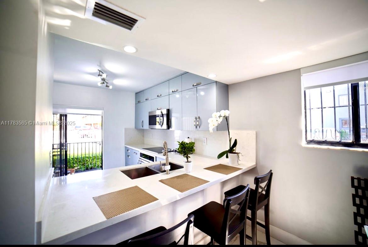 1380 West 41st Street, Unit 101 Hialeah, FL 33012 - Photo 8 of 23 a view of a dining room with a table and chairs