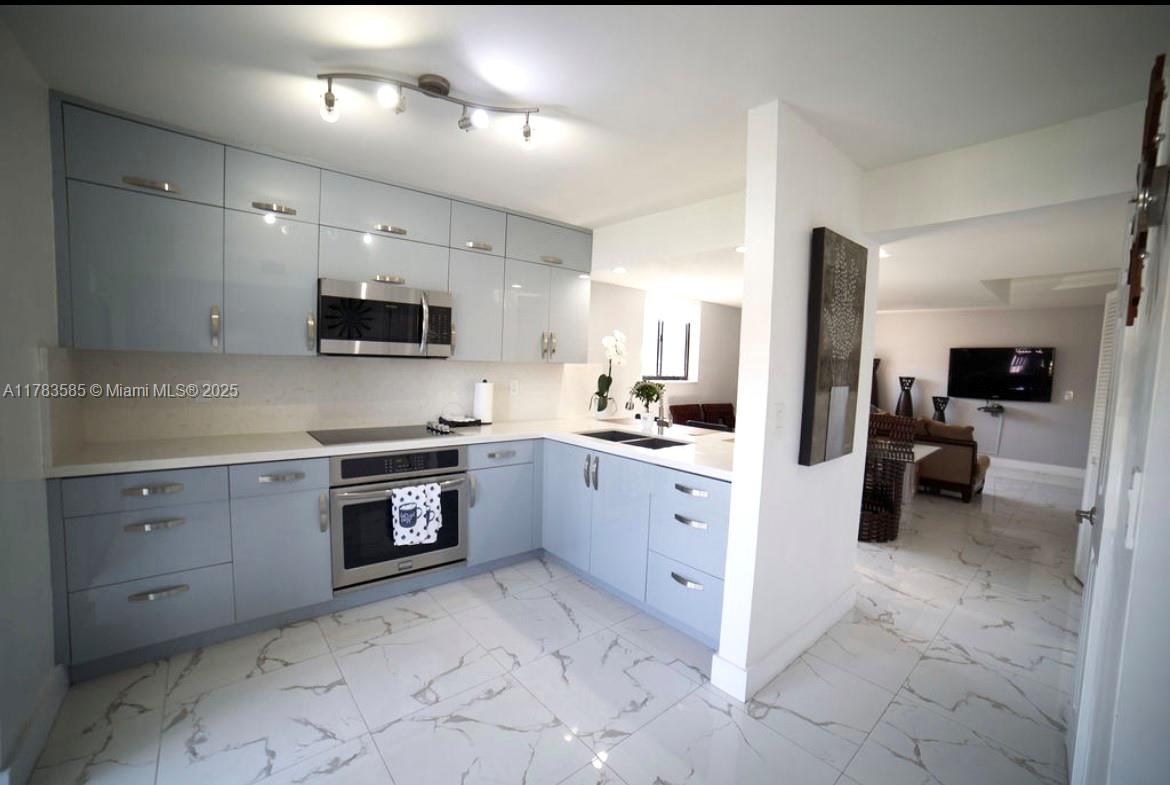 1380 West 41st Street, Unit 101 Hialeah, FL 33012 - Photo 10 of 23 a large kitchen with cabinets