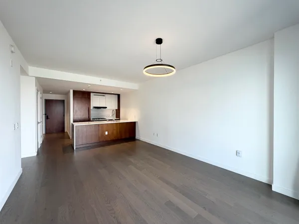 a view of a room with wooden floor and natural light