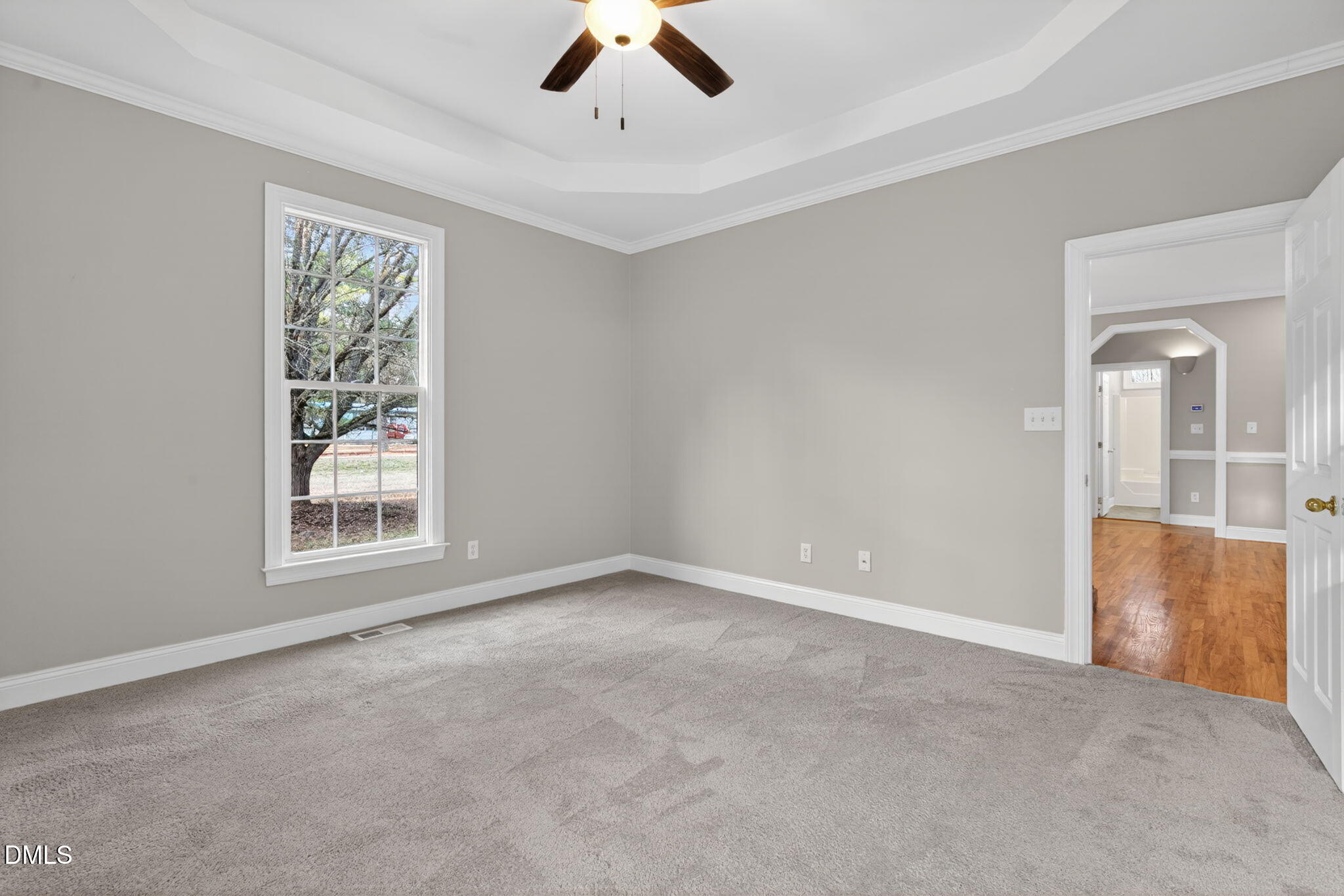 10000 Kennebec Road Willow Spring, NC 27592 - Photo 18 of 38 an empty room with chandelier fan and windows